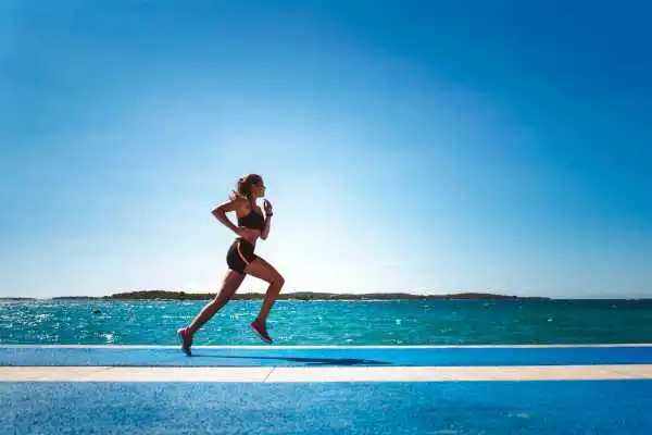 Woman running showing strong leg muscle Wisbech